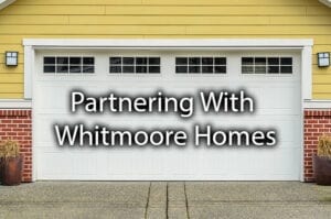 A beautiful garage door with the words; "partnering with Whitmoore Homes."