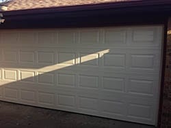Stratford series residential garage door repaired and opener motor replaced to restore working order in the Dallas Tx