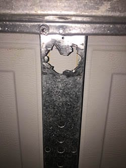 Action Garage Door was called to repair this residential garage door broken linkage in Richardson Texas by their technician Adan Vega