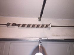 This garage door spring in Richardson Texas home suffered a failure and broke into two pieces so they called Action Garage Doors of Plano Tx