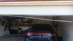 A residential garage door seal at 1249 Whitehorse Dr Lewisville Texas that is broke and in much need of repair by Action Garage Doors professional technicians