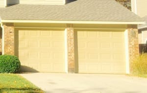 Cream colored two single garage doors in Grapevine Texas repaired by professionals at Action Garage Door