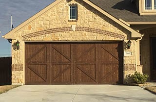 A beautiful residential custom wood two car garage door install and repair in Mansfield Texas by the professionals at Action Garage Doors