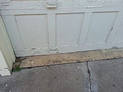 This dilapidated old wooden garage door located at 8467 Forest Hills Blvd Dallas Texas was needing repair or install new one by Action Garage Doors