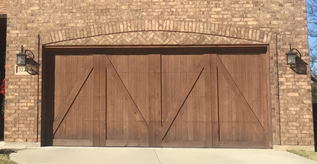 Half bucks, carriage style wooden garage install for new home in Flower Mound TX by the experts at Action Garage Door of Plano Texas