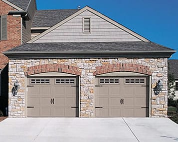 Kennedale Tx custom residential steel garage doors and opener being repaired then installed and serviced by Action Garage Doors Plano