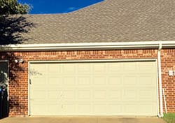 Action Garage Door technicain 3 on a large residential new steel garage door install and repair on a large home in Garland Texas