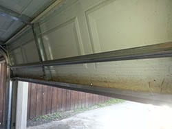 At 6438 Los Altos Dr Mesquite Texas Action Garage Doors technicians replaced and repaired a garage door panel and seal