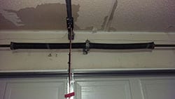 This residential home in Carrollton Texas suffered a garage door spring breakage and Action Garage Doors was called to repair and replace the spring and cable
