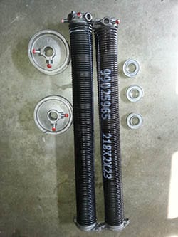 Two new garage door springs ready to be installed by technician 5 in a home in Carrollton Texas by Action Garage Doors