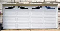 Double white american home and commercial garage doors installed, repaired, and serviced by Action Garage Doors in Missouri City Texas a suburb of Houston