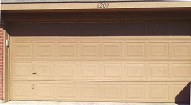 An older residential home that has a very aged garage door needed repairs in Mckinney Texas by Technician 3 Action Garage Doors